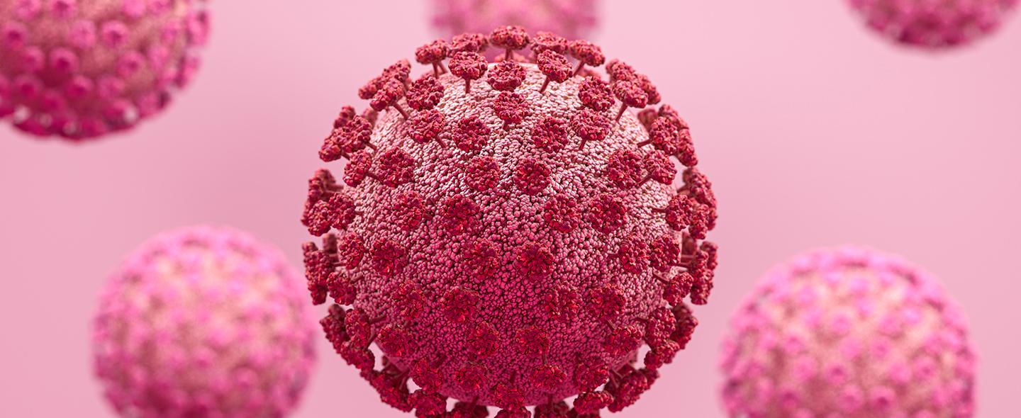 Koronaviruksia vaaleanpunaisella taustalla